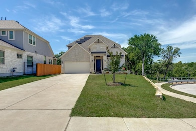 View of front of house featuring driveway, a gara