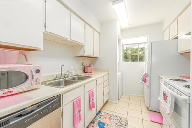 Kitchen with white appliances, light countertops,