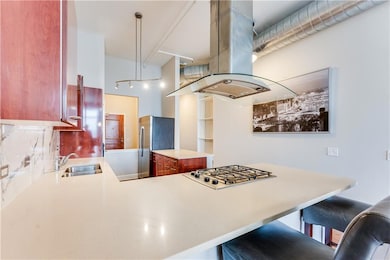 Kitchen featuring light countertops, a kitchen bar
