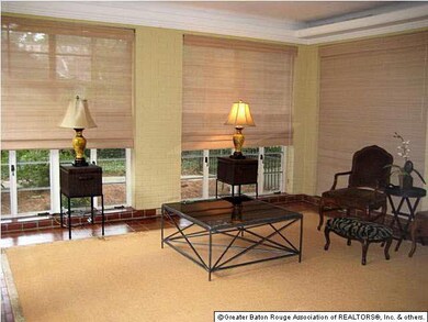 Light-filled sunroom with 3 walls of windows, over