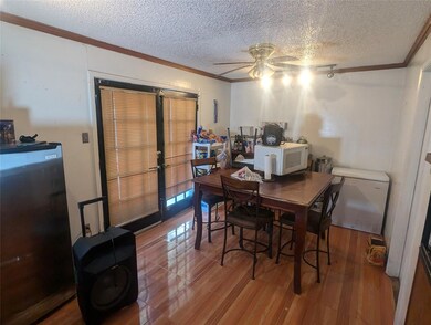 Dining room with ceiling fan, a textured ceiling, 