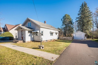 View of front of house with a front yard, an outdo
