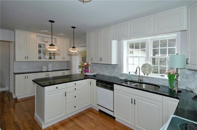 The updated Kitchen with quartz counters, hardwood