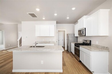 Chef’s Dream Kitchen! Sleek granite countertops, stainless steel appliances, and crisp white cabinetry create a perfect blend of style and functionality.