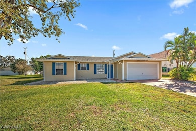 Ranch-style home with a front lawn, a garage, and