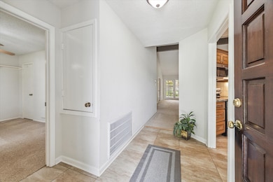 Entry way with kitchen on the right and a bedroom