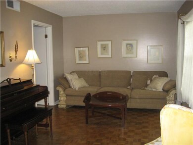 Living room with hardwood floors, lots of light fr