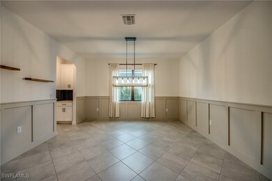 Unfurnished dining area featuring a decorative wal