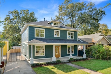 View of front of home with covered porch and a front yard