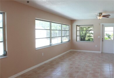 Back living area overlooking lanai, pool, & canal!