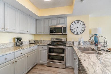 Kitchen with gray cabinets, sink, stainless steel 