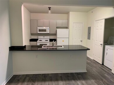 Kitchen featuring kitchen peninsula, white applian
