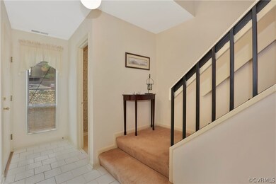 Foyer has ceramic tile leading into the kitchen an