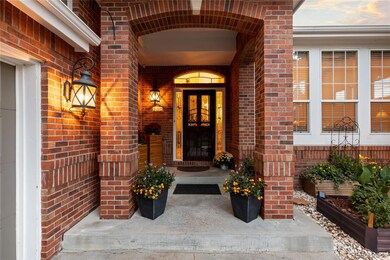 Covered front entry with brick pillars
