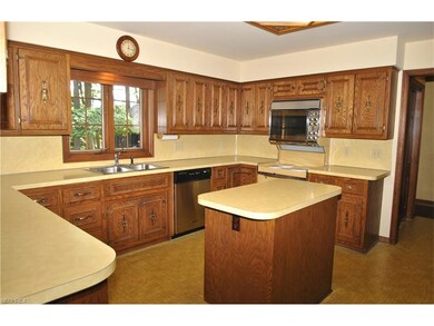 The bright kitchen includes appliances, island, de