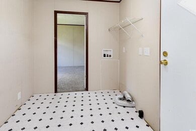 Washroom with light carpet and hookup for a washin