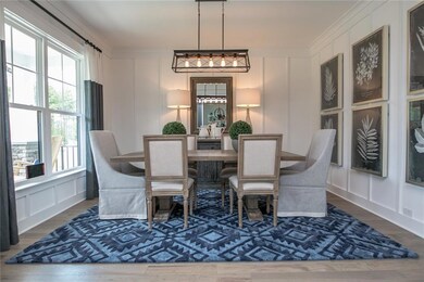 The first floor offers a large dining room with board and batten trim. The office has a closet and barn doors. Hardwoods throughout most of the downstairs. Spacious first floor guest suite. DESIGNER Kitchen with huge quartz island and walk-in pantry.