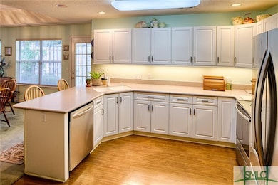 Light, bright, white kitchen. Corian counter tops.