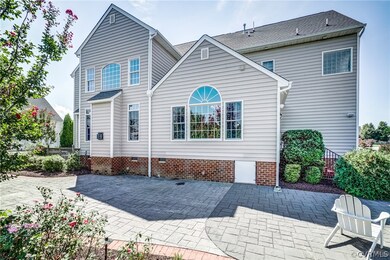 Expansive stamped concrete patio spans entire leng