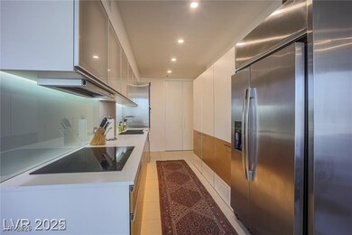 Kitchen with stainless steel refrigerator with ice dispenser, white cabinetry, modern cabinets, light tile patterned flooring, and recessed lighting