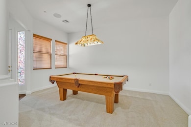 Game room with light colored carpet, billiards tab
