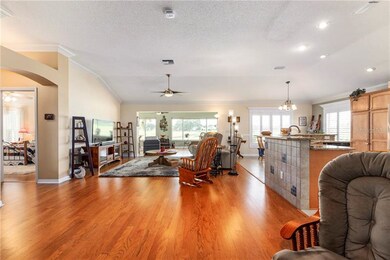 Living Room with hardwood flooring, crown molding 