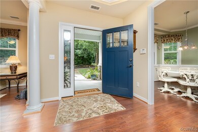 Hardwood floored entrance foyer with crown molding