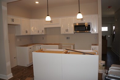 White cabinets with Bengal White Granite.  Stainless Steel Appliance's include Range, Dishwasher, Microwave and Refrigerator.