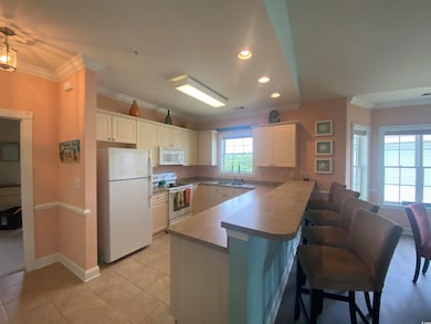 Kitchen featuring white cabinetry, light tile patt