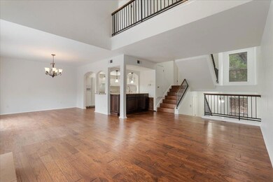 Unfurnished living room with a towering ceiling, 