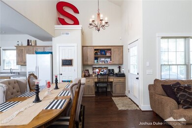 The open dining/kitchen space has a built-n desk for maximum space efficiency.  And notice the pantry for added storage!