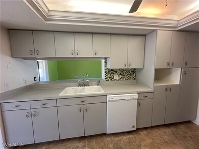 Kitchen featuring White Appliances, Light Gray Cou