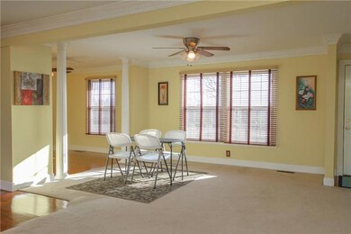 The Living Room has Carpet, Masonry Fireplace, Built-In Bookshelf and French Doors leading to Deck.