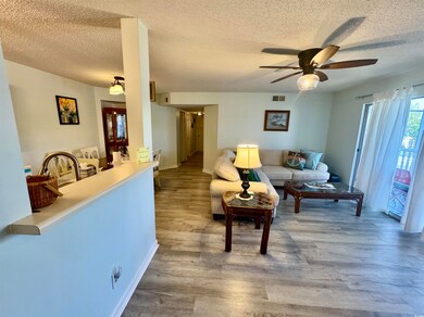 Living room featuring baseboards, a textured ceili
