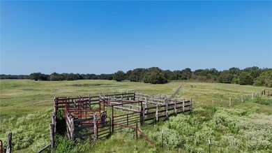 View of yard with fence and a rural view