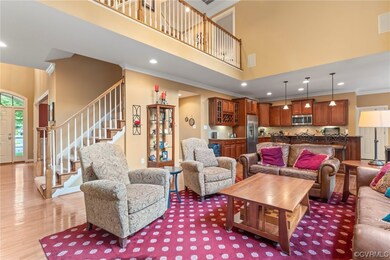 Living room with a high ceiling, crown molding, an
