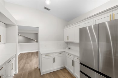 Kitchen featuring lofted ceiling, stainless steel