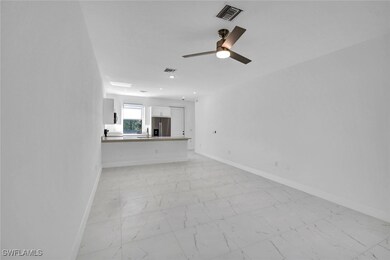 Unfurnished living room with a sink, marble finish