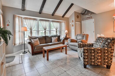 Living room featuring a textured ceiling, light ti