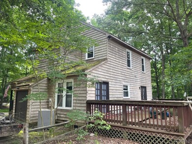 Back of house with a wooden deck