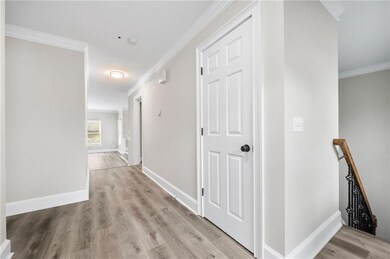 Corridor with light wood-type flooring, ornamental