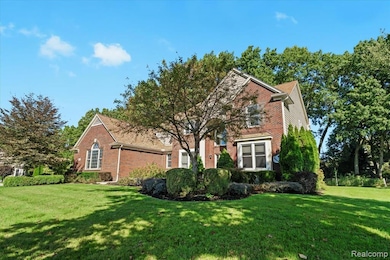 Obstructed view of property featuring brick siding and a front lawn