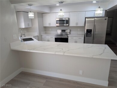 Kitchen with stainless steel appliances, a peninsu