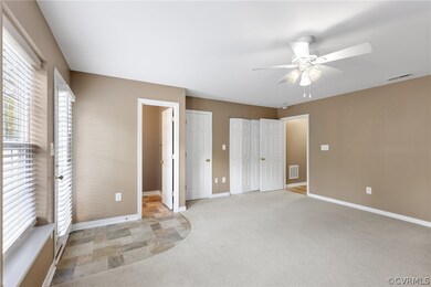 Unfurnished bedroom featuring multiple closets, ceiling fan, and light tile floors