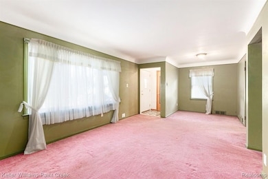 The rebuilt porch entry opens to a large sunlit living room flanked by the dining nook.