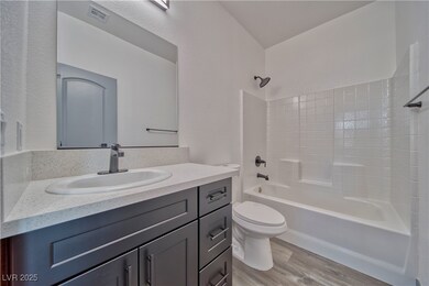 Guest bathroom is sleek with  the shower/tub combo