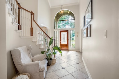The two-story entry has ample space to receive fri