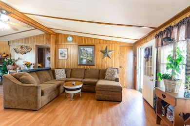 Living area with vaulted ceiling with beams, a cei