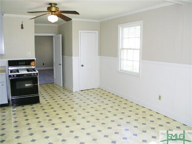 Kitchen looking towards living room.  Gas range in