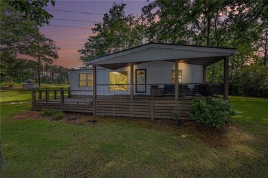 Back of property with a lawn and covered porch